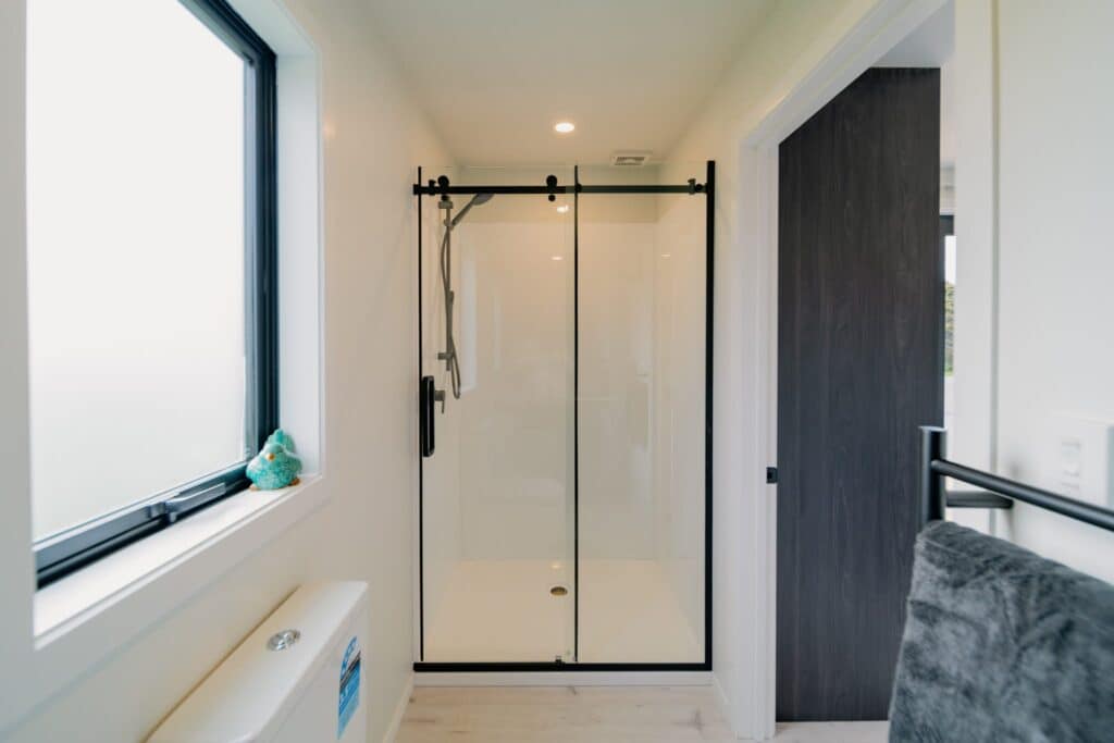 Bathroom with a frameless sliding shower in a Paragon Portables home